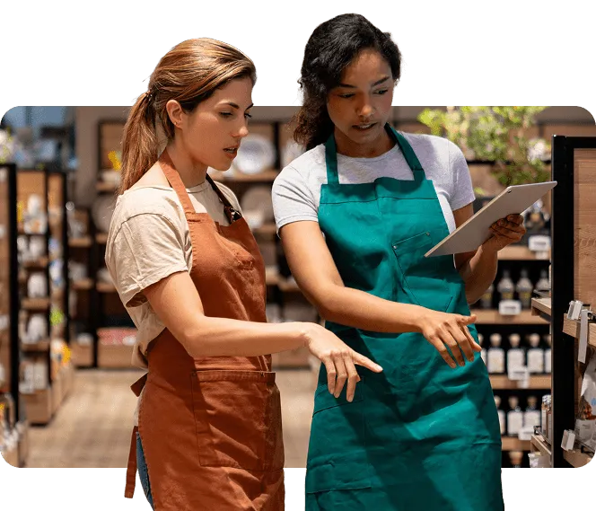 Retail employees completing mobile training on a tablet while working on the shop floor, with gamified learning performance metrics