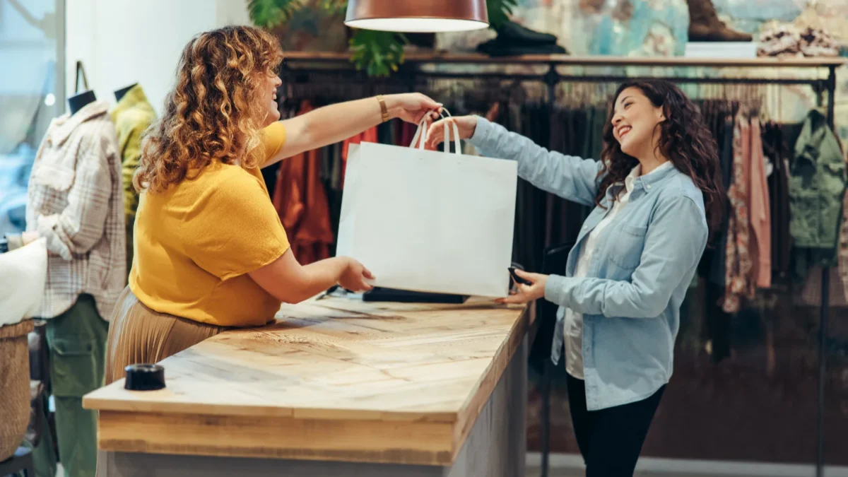 retail store staff serving a a happy customer