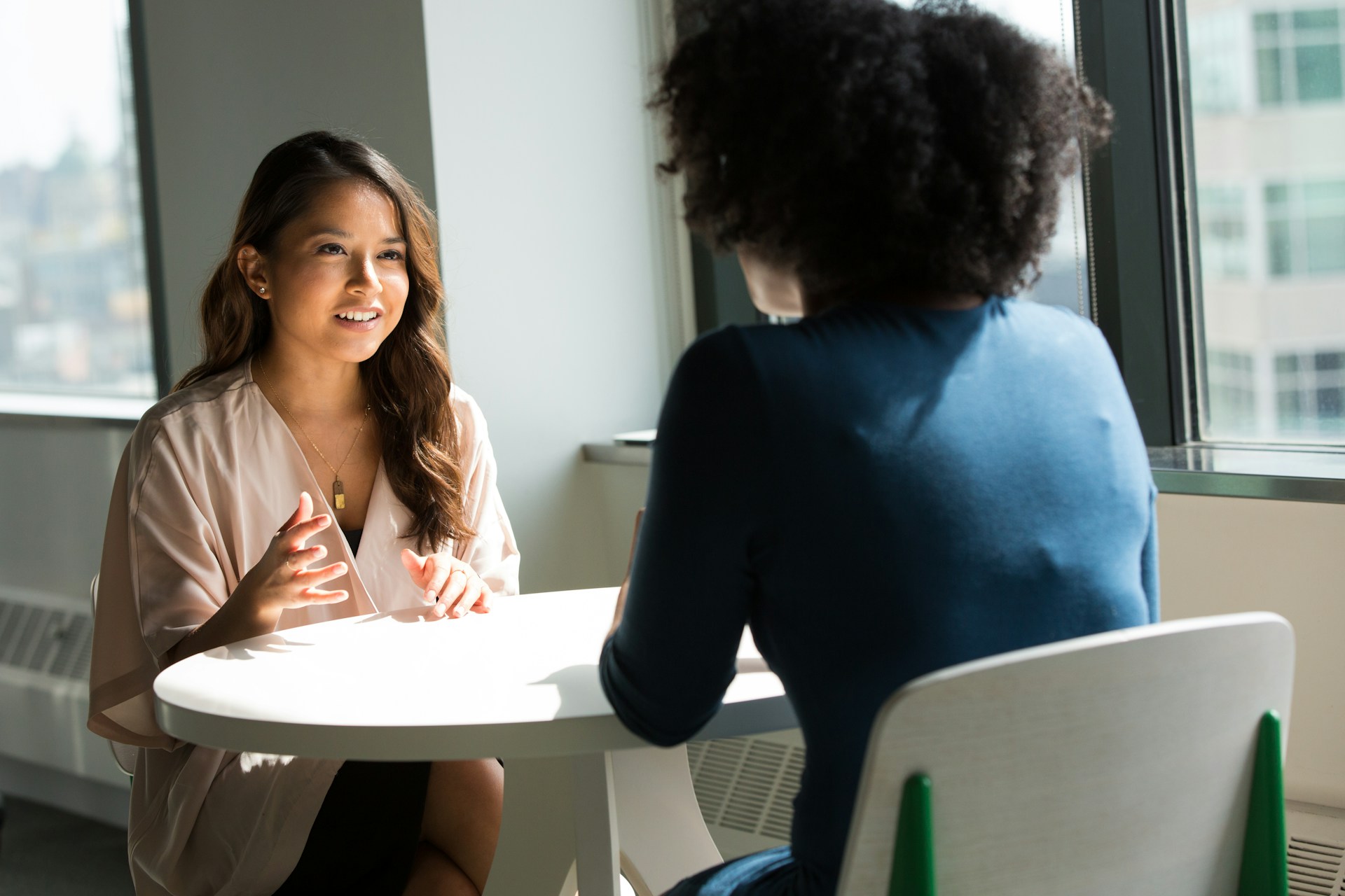 two people sat down having a conversation