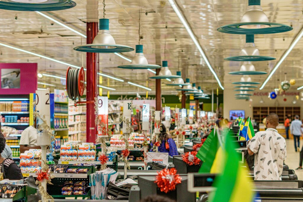 Supermarket checkouts with numbered lane signs, tinsel and confectionery displays.